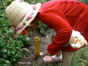Young gardener watches water drain